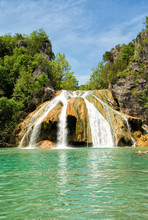 Waterfall At Turner Falls, Oklahoma, With Beautiful Aqua Colored Water Under Blue Spring Sky
