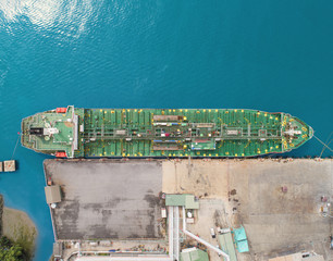 Wall Mural - Aerial top view Oil ship tanker at loading dock from refinery on the sea.