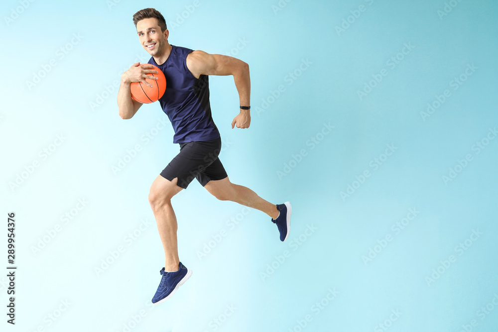 Running basketball player on color background