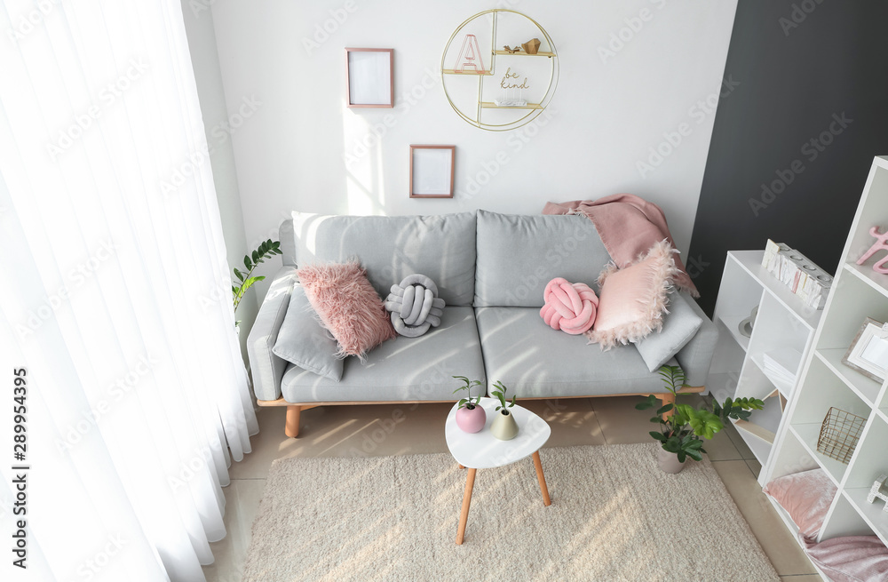 Interior of beautiful modern room with comfortable sofa