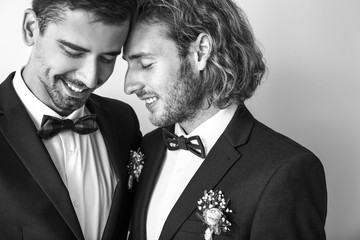 Wall Mural - Black and white portrait of happy gay couple on their wedding day