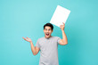 © Atstock Productions - Young cheerful asian male in a excited gesture promoting a blank placard