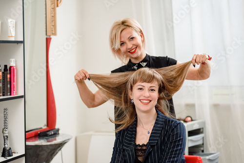 Portrait Of Young Hairdresser Posing With Happy Client In Beauty
