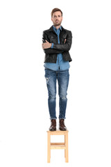 Poster - man standing on chair with arms crossed