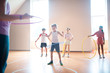© zinkevych - Boys and girls rolling hula-hoops at physical training