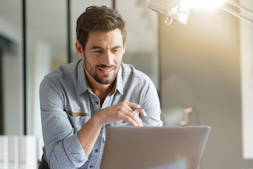 Wall Mural - Modern man working in office