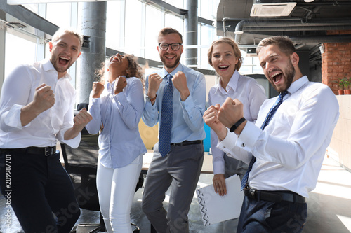 Fotografía Five happy modern business people are keeping arms raised and expressing joyful
