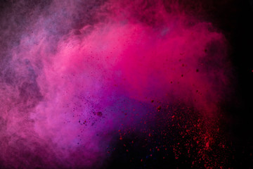 Wall Mural - freeze motion of colored dust explosion isolated on black background.