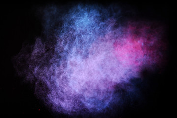 Wall Mural - freeze motion of colored dust explosion isolated on black background.