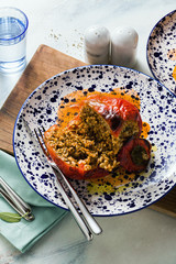 Wall Mural - sweet stuffed peppers on a served table. cut. shot from above.