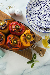 Wall Mural - freshly baked stuffed peppers with lentils and rice, in a glass baking dish. festive vegan food