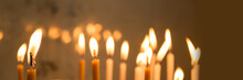 Close Up Of Candles In A Church, Panoramic Christmas And Holiday Lights Background