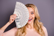 © deagreez - Close-up portrait of nice attractive cheerful crazy overjoyed wavy-haired girl client holding in hands fan of 100 usd interest closing face isolated over gray violet purple pastel color background