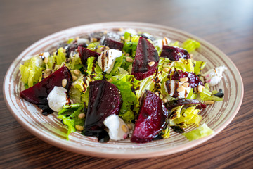 Wall Mural - Homemade Healthy Salad with Beetroot, Goat Cheese, Pine Nuts and Balsamic Cream