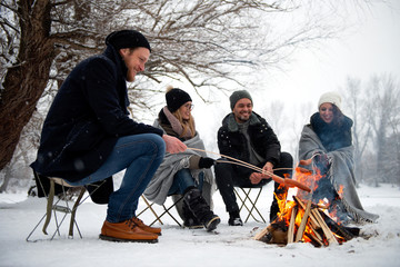 Wall Mural - Friends having barbecue on a snowy day