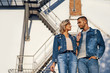 © GVS - Young beautiful woman and man in jeans cloth posing on urban architecture