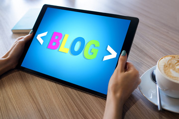 Wall Mural - tablet with blog text the on screen. social network, communication and internet marketing concept.