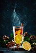 Christmas or New Year hot winter drink, spicy grog cocktail, sangria or mulled wine with tea, lemon, rum, cinnamon, anise. Rustic style, copy space