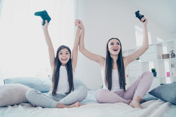 Poster - Portrait of two nice beautiful attractive lovely charming long haired cheerful cheery glad excited positive people celebrating battle win amusement in light white interior room indoors