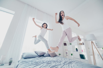 Poster - Low below angle full length body size view of two nice beautiful lovely cheerful childish playful girlish people having fun spending free time holiday rejoicing in light white interior house indoors