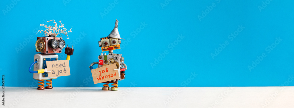 Job search concept. Two robots wants to get a job. Smiley unemployed robotic characters with a cardboard sign and handwritten text Need a job and Job Wanted. Blue gray background, copy space for text - obrazy, fototapety, plakaty 