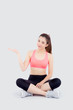 © NT_studio - Beautiful portrait young asian woman in sport clothes with satisfied and confident presenting and show something isolated on white background, asia girl sitting exercise for fit with health concept.