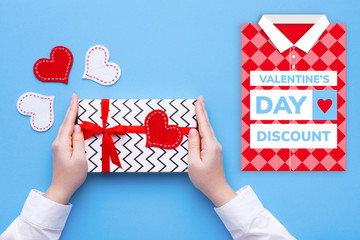 Wall Mural - Person holding a present for Saint Valentine's day in his hands. Beautiful colorful background to st. Valentine day. Greeting card with red hearts. Wedding's invitation. Love expression