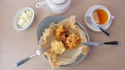 Wall Mural - Julienne baked in dough served on a plate on baker paper with tea and butter. Top view