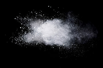Wall Mural - freeze motion of white color powder exploding on dark background.