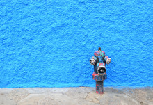  Painted Fire Hydrant And  Blue Wall In Background