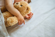 © kaloriya - Little baby sleeping and embracing soft toy bear, close-up on hands