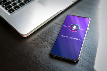 Poster - Voice recognition AI audio technology concept. Close-up smart mobile phone with a microphone and a wave icon on the screen. Virtual assistant app on smartphone.