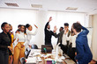© AS Photo Family - Multiracial business people standing at office and put hands up. Diverse group of employees in formal wear.