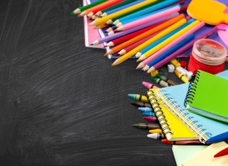 Sticker - Colorful school supplies on wooden background