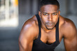 Inspirational exercise and fitness portrait of african american male athlete, intense and powerful expression