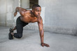 © elnariz - Shirtless male african american athlete training in urban city concrete background, sprinter, runner, jogger, muscular toned build training for race