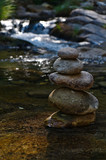 Fototapeta Desenie - Zen rocks or pebble stack on river waters. Peaceful and spiritual theme