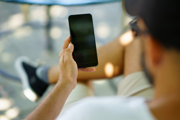 Man using smartphone. Male hand holding smartphone