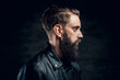 © Fxquadro - Portrait of hopeless bearded man with hairstyle on the black background.