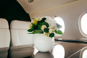 modern and comfortable interior of business jet aircraft with decor