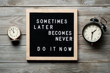 Inspirational Motivational Quote Sometimes Later Becomes Never. Do It Now Words On A Letter Board On Wooden Background Near Vintage Alarm Clocks. Success And Motivation Concept.