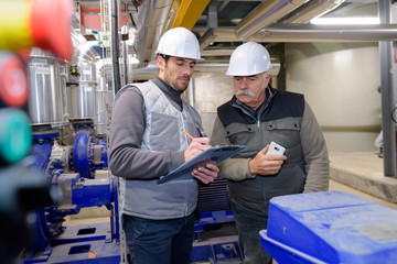 two engineer working in the boiler room