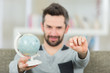 © auremar - man holding globe and sim card