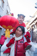 © xixinxing - Parent carrying child on shoulders dressed in holiday attire