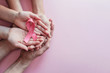 hands holding pink ribbons, Breast cancer awareness and October Pink day, world cancer day