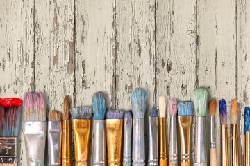 Wall Mural - Row of artist paint brushes  on background