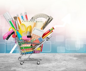 Wall Mural - Colorful school supplies in shopping cart