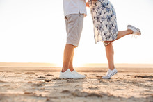 Cropped Photo Of Beautiful Caucasian Couple Kissing And Hugging While Walking On Sunny Beach