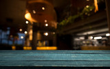 Fototapeta Londyn - Empty wood table top on blur light gold bokeh of cafe restaurant in dark background