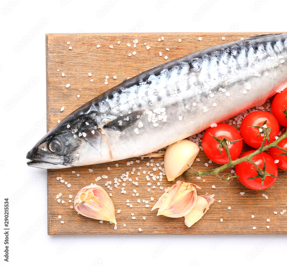 Board with raw mackerel fish, tomatoes and garlic on white background